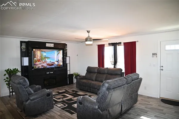 a living room with furniture and a wooden floor