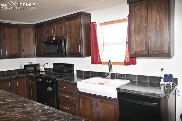a kitchen with a refrigerator and cabinets