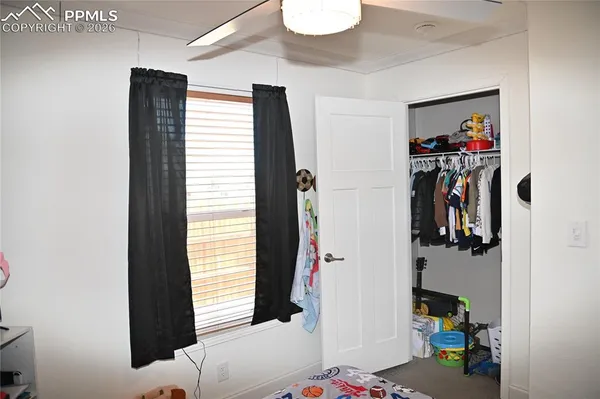 a bathroom with a window and mirror on the wall