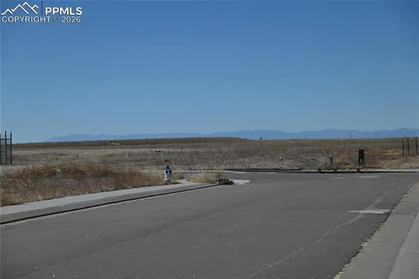 a view of front door and a yard