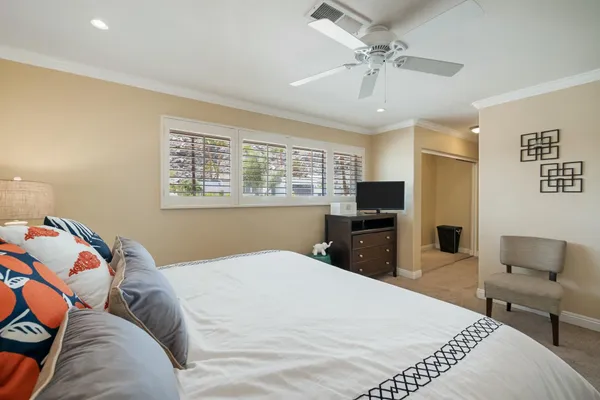 a bedroom with a large bed and a flat screen tv