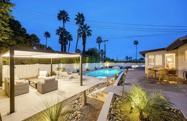 a bunch of white furniture and a black white umbrella