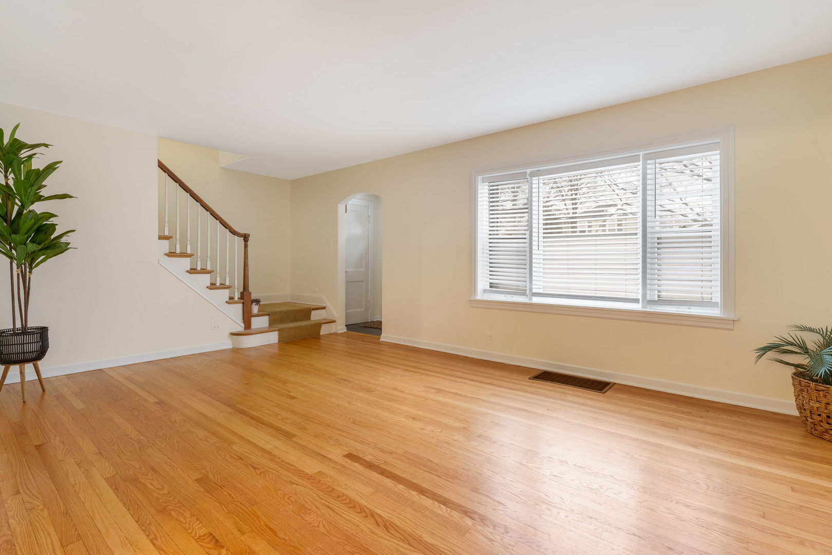 1927 Warren Street Evanston, IL 60202 - Photo 5 of 25 a view of an empty room with wooden floor and a window