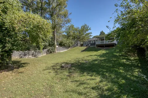 a backyard of a house with yard and trampoline