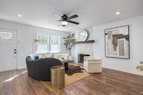 a living room with furniture and a fireplace