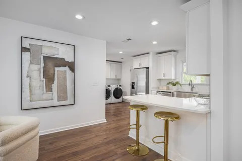 a large kitchen with a table and chairs