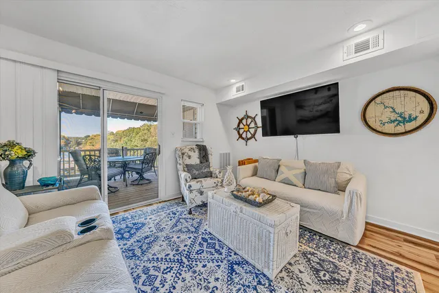 a living room with furniture a rug and a flat screen tv