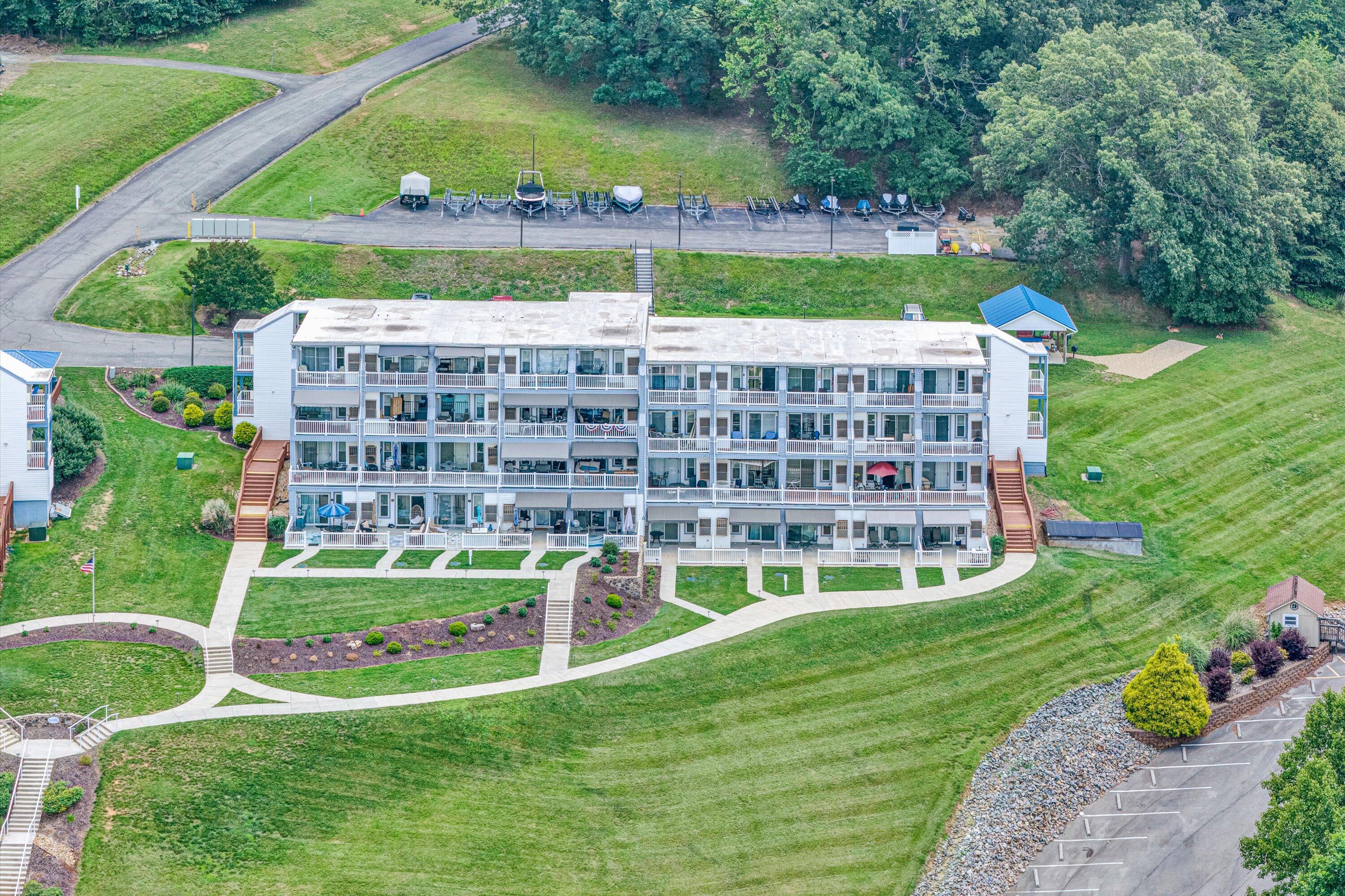 1089 Bluewater Drive, Unit 414 Moneta, VA 24121 - Photo 21 of 30 a view of a multi story residential apartment building with a yard and outdoor seating