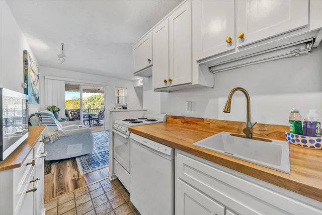 a kitchen with granite countertop a sink and a stove top oven