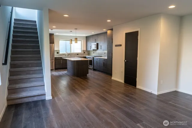 a view of kitchen with stainless steel appliances refrigerator microwave and stove