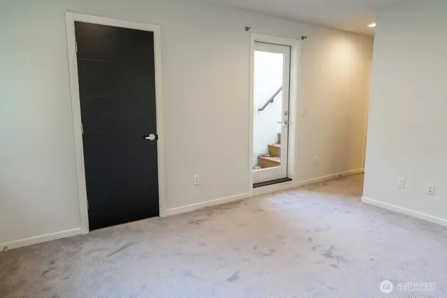 an empty room with windows and closet