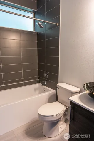 a bathroom with a toilet a sink and bathtub