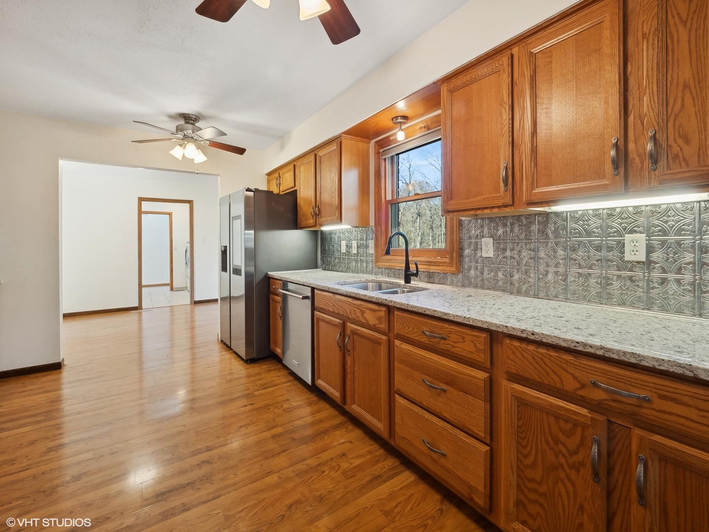 5881 Tipple Road Rockford, IL 61102 - Photo 15 of 32 a kitchen with stainless steel appliances granite countertop wooden cabinets a sink and dishwasher