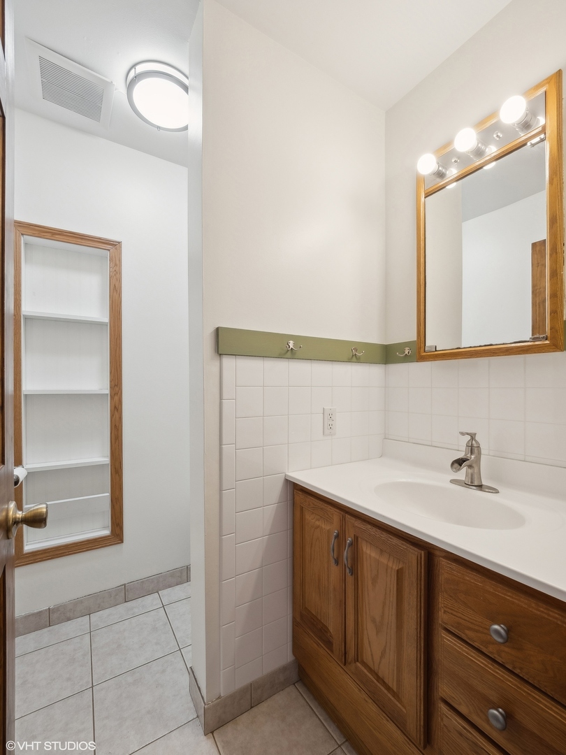 5881 Tipple Road Rockford, IL 61102 - Photo 18 of 32 a bathroom with a sink and a mirror