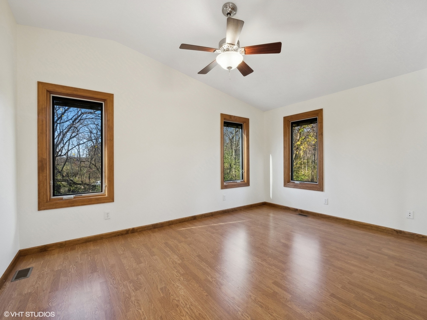 5881 Tipple Road Rockford, IL 61102 - Photo 19 of 32 a view of an empty room with wooden floor and a window