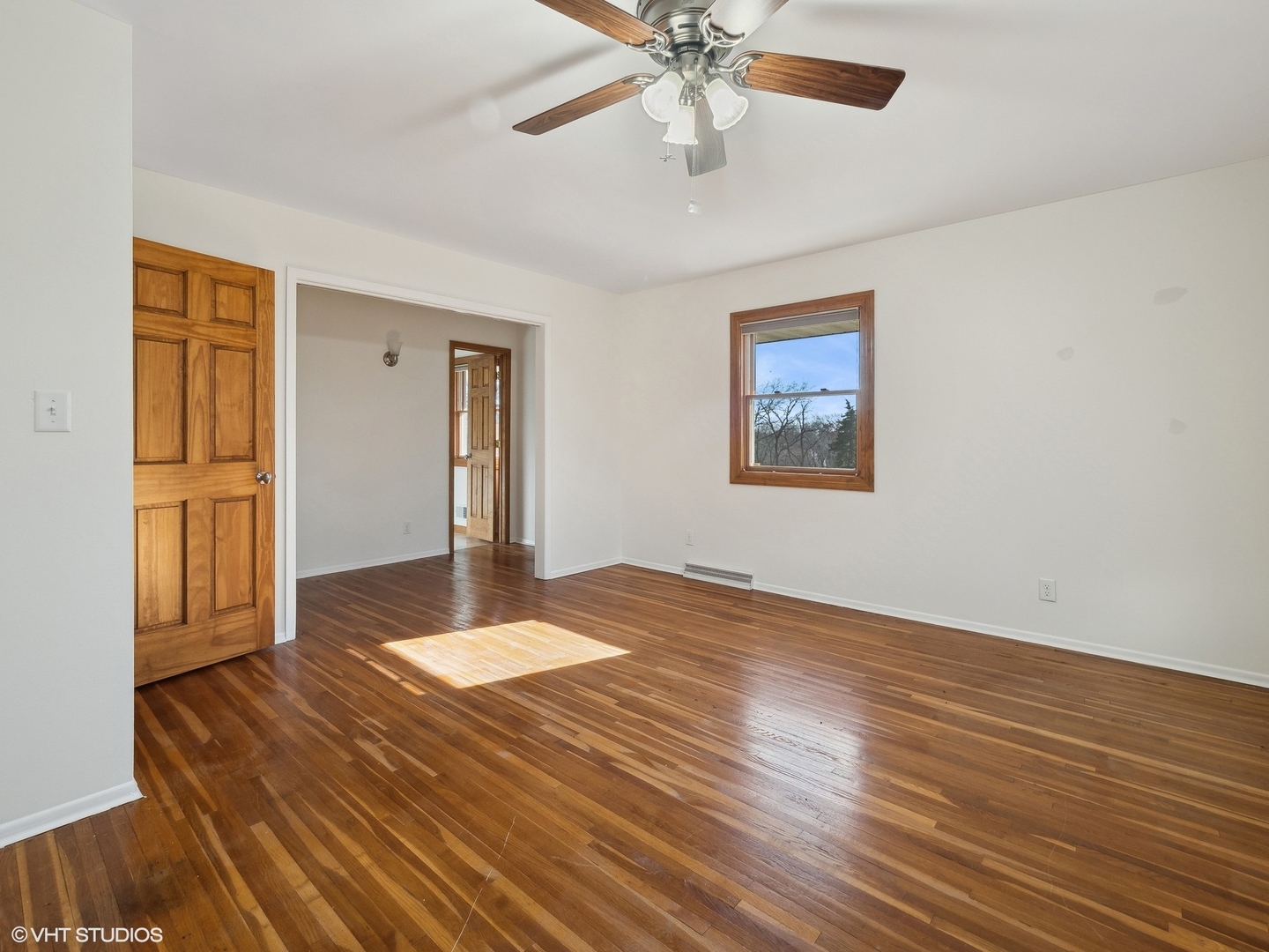 5881 Tipple Road Rockford, IL 61102 - Photo 25 of 32 a view of an empty room with wooden floor and a ceiling fan