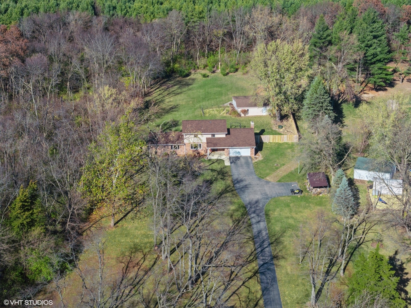 5881 Tipple Road Rockford, IL 61102 - Photo 4 of 32 a view of a garden with plants and large trees