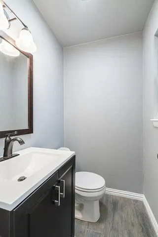 a bathroom with a sink a toilet and mirror