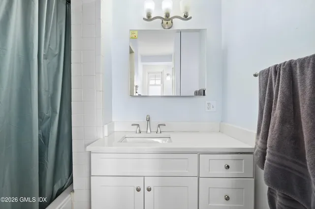 a bathroom with a sink a vanity and a mirror