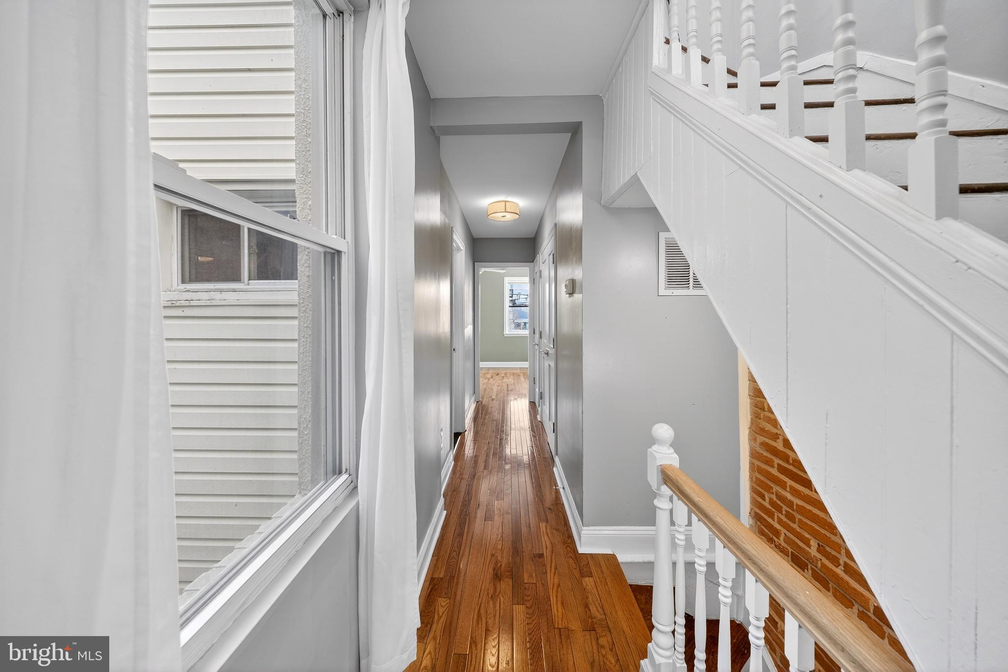 7 East Fort Avenue Baltimore, MD 21230 - Photo 39 of 73 a view of a hallway with wooden floor and staircase