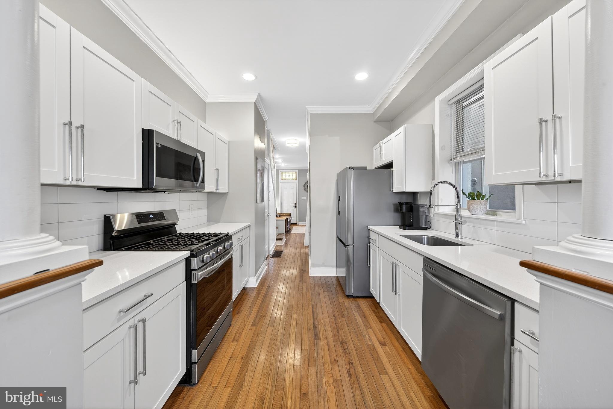 7 East Fort Avenue Baltimore, MD 21230 - Photo 4 of 73 a large kitchen with stainless steel appliances granite countertop a stove top oven a sink dishwasher and a refrigerator with wooden floor