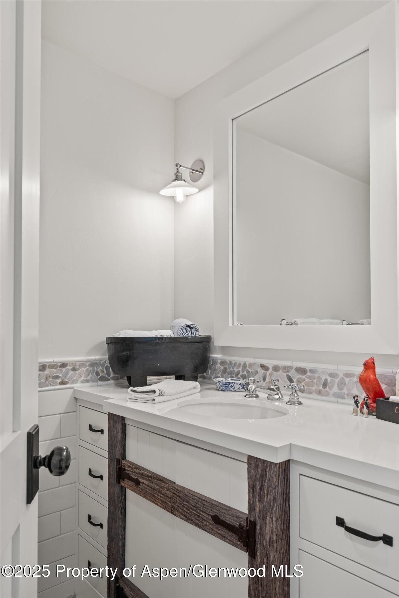 9555 Castle Creek Road Aspen, CO 81612 - Photo 27 of 42 a sink and a mirror