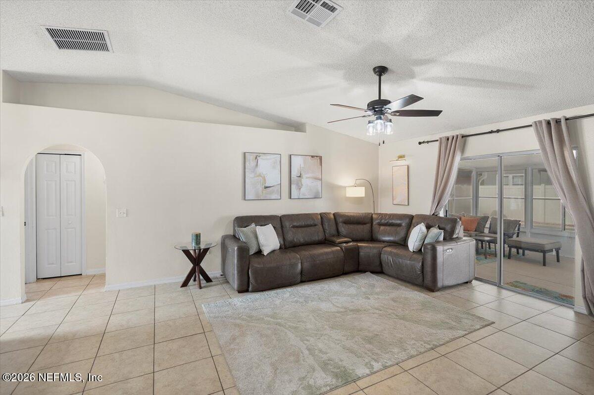 10310 Woodley Point Road Jacksonville, FL 32218 - Photo 9 of 30 a living room with furniture and a chandelier