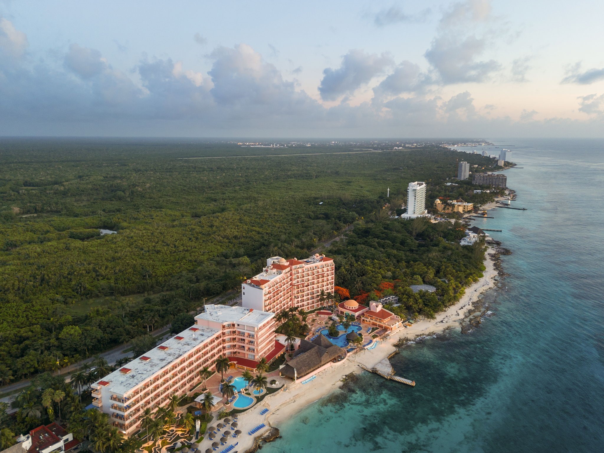 6 Country Club, Unit 4 Nome, TX 77629 - Photo 35 of 45 This commanding coastal view features the exclusive north hotel zone of Cozumel, showcasing a premium collection of beachfront resort towers positioned directly along the island's striking turquoise shoreline. The Cozumel International Airport is visible at the top of this photo - making travel on and off the island convenient.