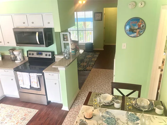 a living room with furniture a rug and a fireplace