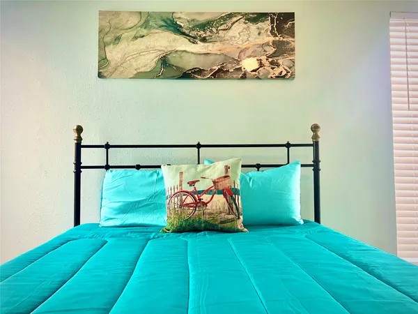 a bed room with a bed and wall painting