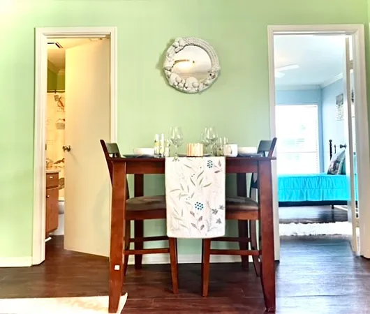 a view of a dining room with furniture and wooden floor