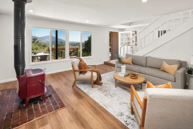 a living room with furniture and a floor to ceiling window