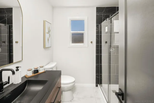 a bathroom with a toilet a sink and shower