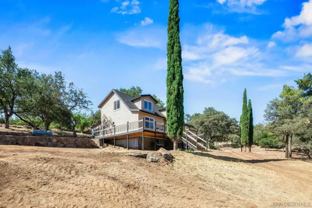 a wooden bench sitting in front of a building