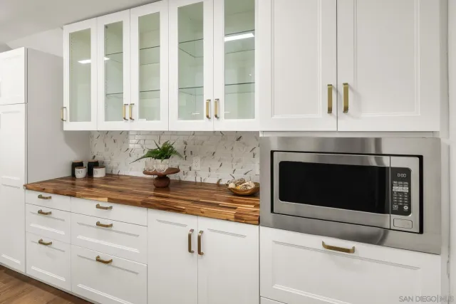 a kitchen with granite countertop white cabinets stainless steel appliances and sink