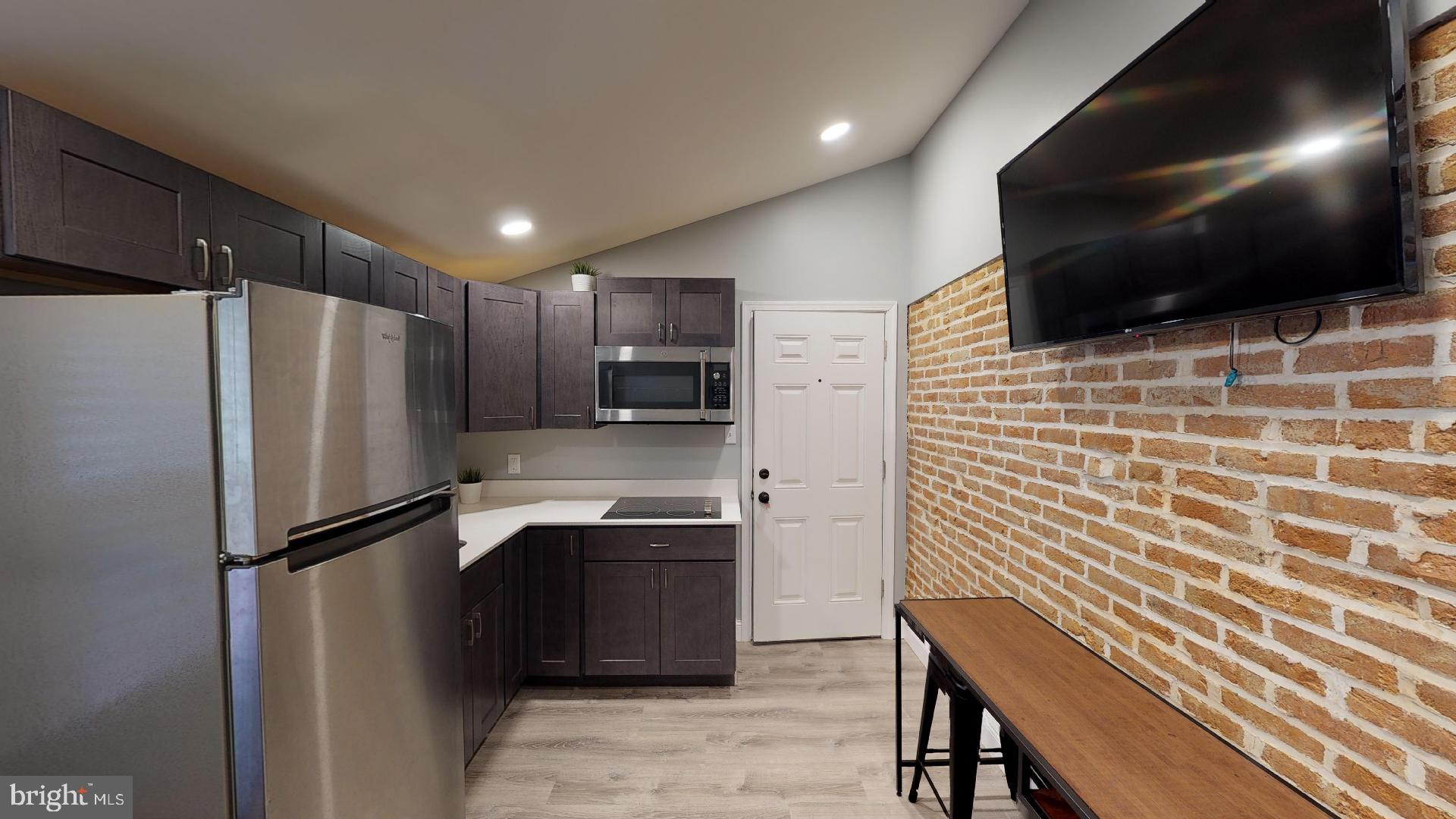 a kitchen with stainless steel appliances a refrigerator and a microwave