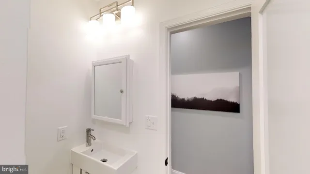 a bathroom with a sink and mirror