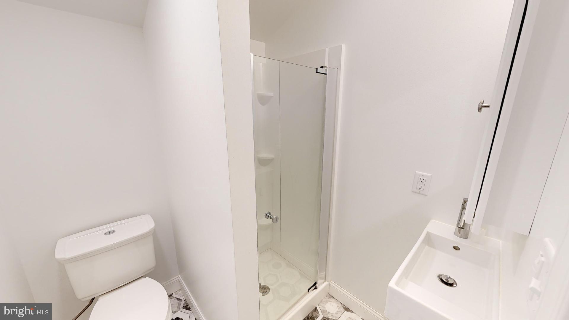 27 South Church Street, Unit 1 West Chester, PA 19382 - Photo 14 of 17 a white toilet sitting next to a bath tub