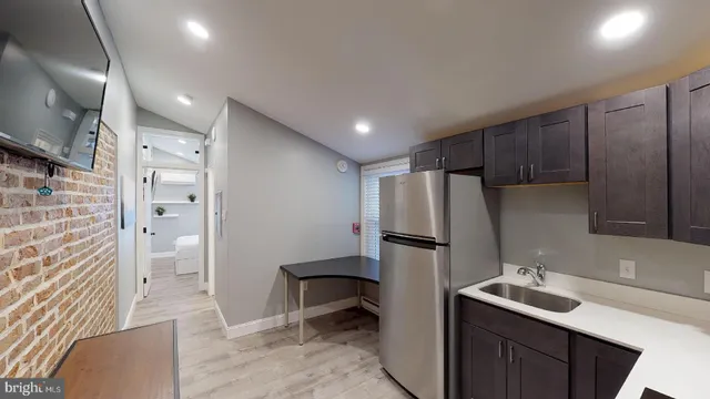 a kitchen with a refrigerator and a sink