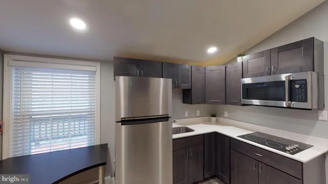 a kitchen with a refrigerator sink and microwave