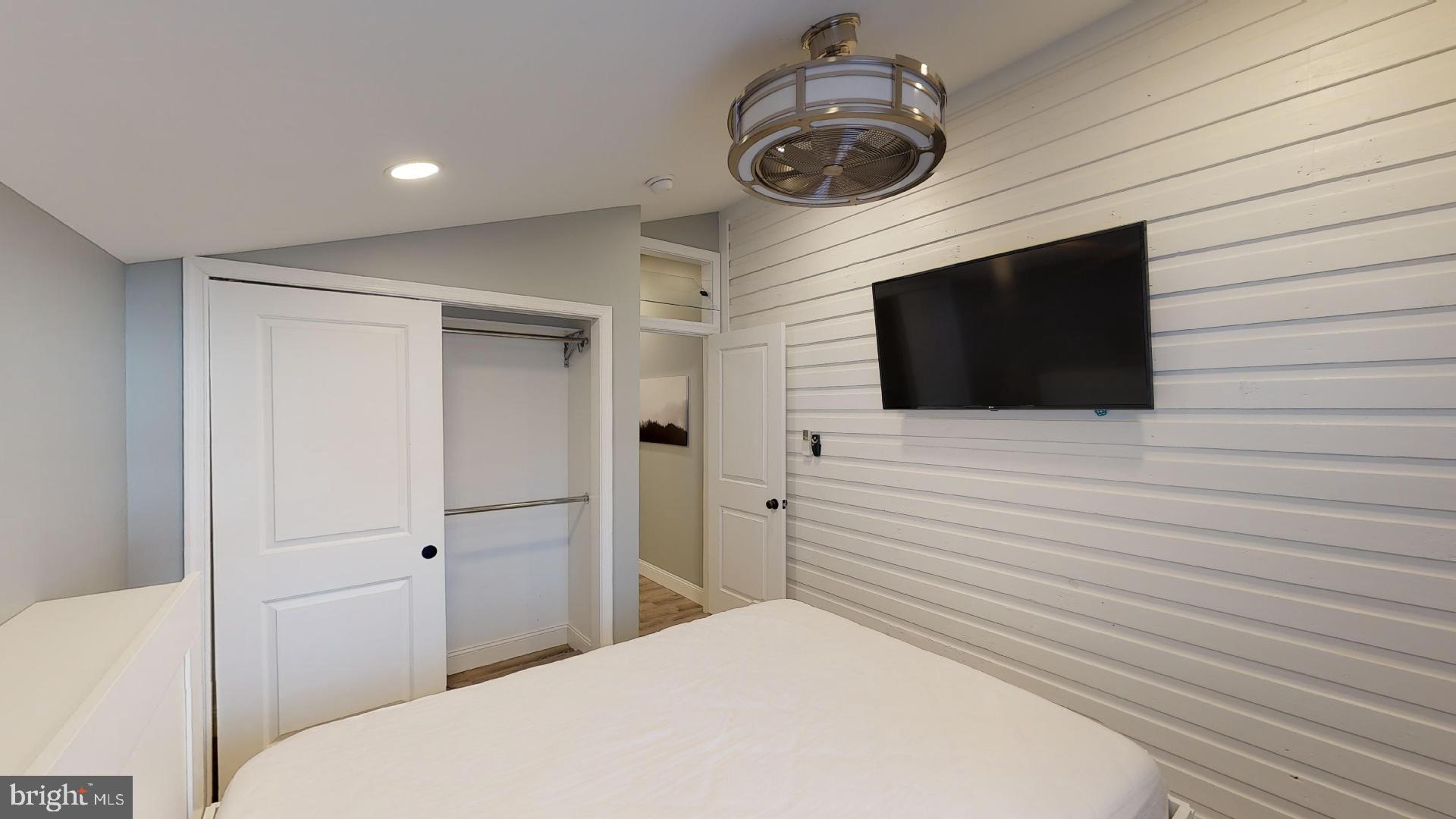 27 South Church Street, Unit 1 West Chester, PA 19382 - Photo 9 of 17 a bedroom with a bed and a flat screen tv