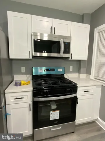 a kitchen with stainless steel appliances a stove a microwave and cabinets