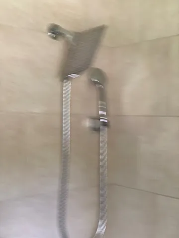 a bathroom with a granite countertop sink and a toilet