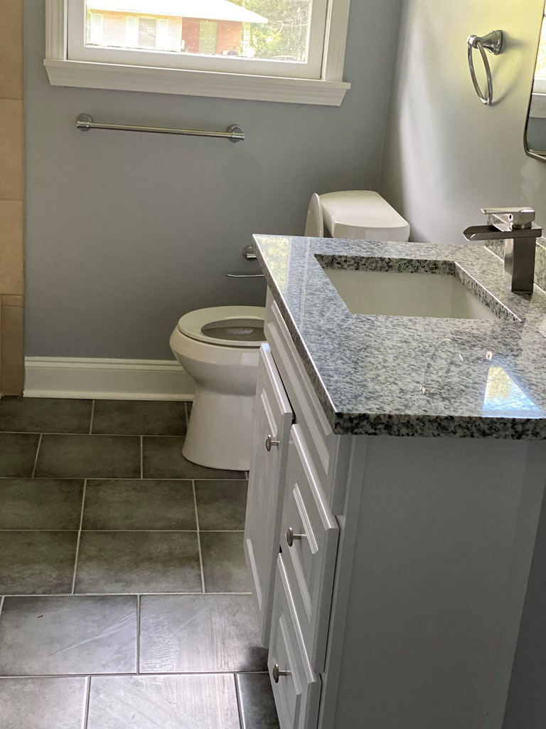1061 Dunbar Avenue Columbus, GA 31906 - Photo 13 of 23 a bathroom with a granite countertop sink and a toilet