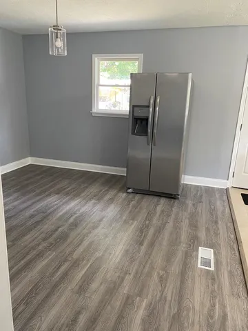 a kitchen with a refrigerator stove and white cabinets