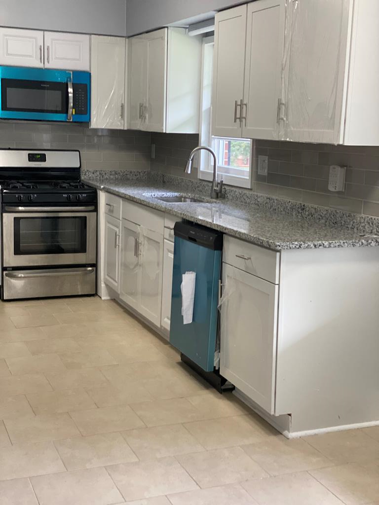 1061 Dunbar Avenue Columbus, GA 31906 - Photo 19 of 23 a kitchen with stainless steel appliances granite countertop a stove a sink and a microwave