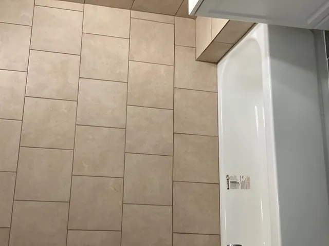 a white bath tub sitting next to a window