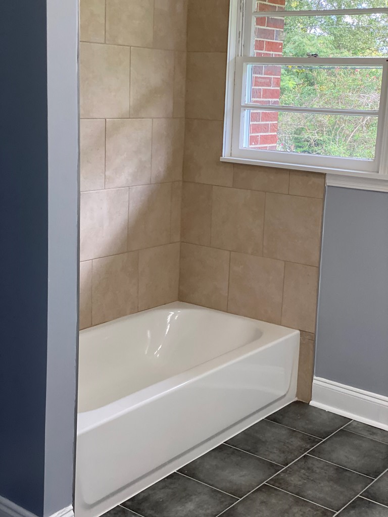 1061 Dunbar Avenue Columbus, GA 31906 - Photo 8 of 23 a white bath tub sitting next to a window