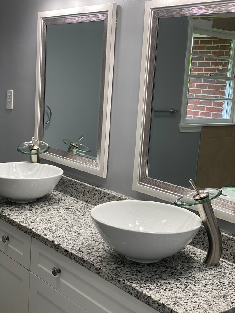 1061 Dunbar Avenue Columbus, GA 31906 - Photo 9 of 23 a view of a bathroom with a granite countertop sink and mirror
