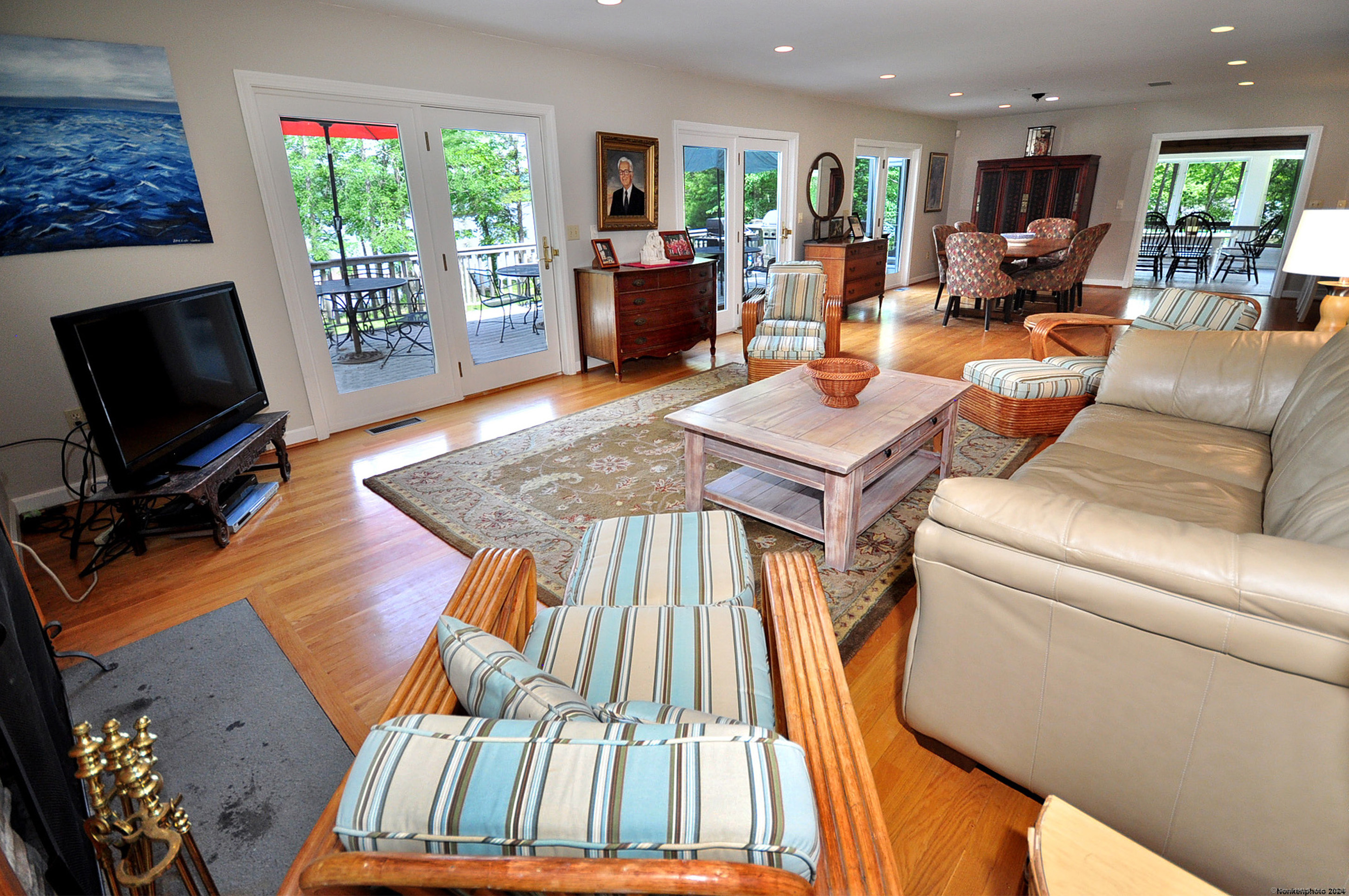 72 Sandy Beach Road Goshen, CT 06756 - Photo 12 of 33 a living room with furniture a flat screen tv and a floor to ceiling window